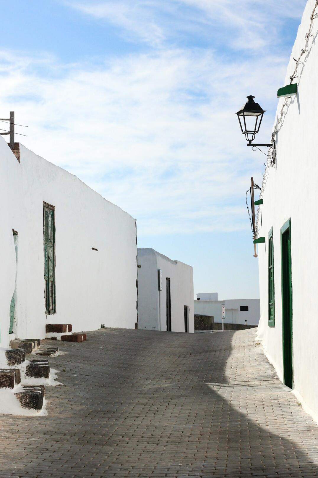 Whitewashed village street in José Ignacio with lighthouse